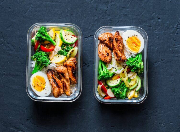 Rice,,Stewed,Vegetables,,Egg,,Teriyaki,Chicken,-,Healthy,Balanced,Lunch Rice, stewed vegetables, egg, teriyaki chicken - healthy balanced lunch box on a dark background, top view. Home food for office concept