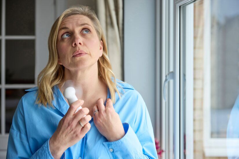 Menopausal,Mature,Woman,Having,Hot,Flush,At,Home,Cooling,Herself Hot flash