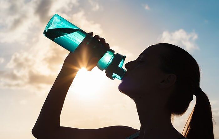 Girl drinking water after a run