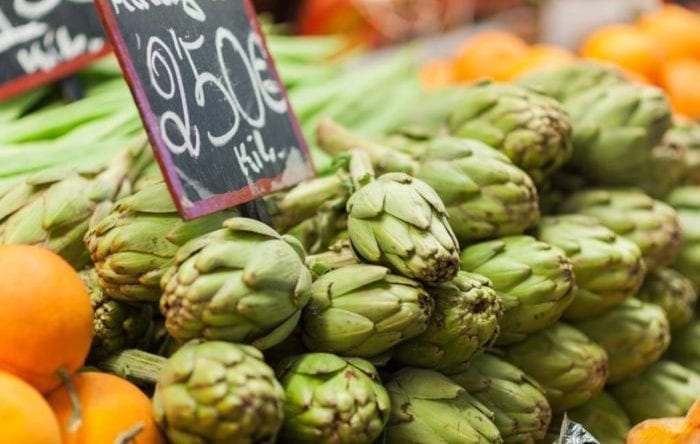 Artichokes for sale on display on a counter