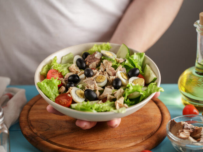mediterranean tuna salad in a bowl with olives and tomatoes