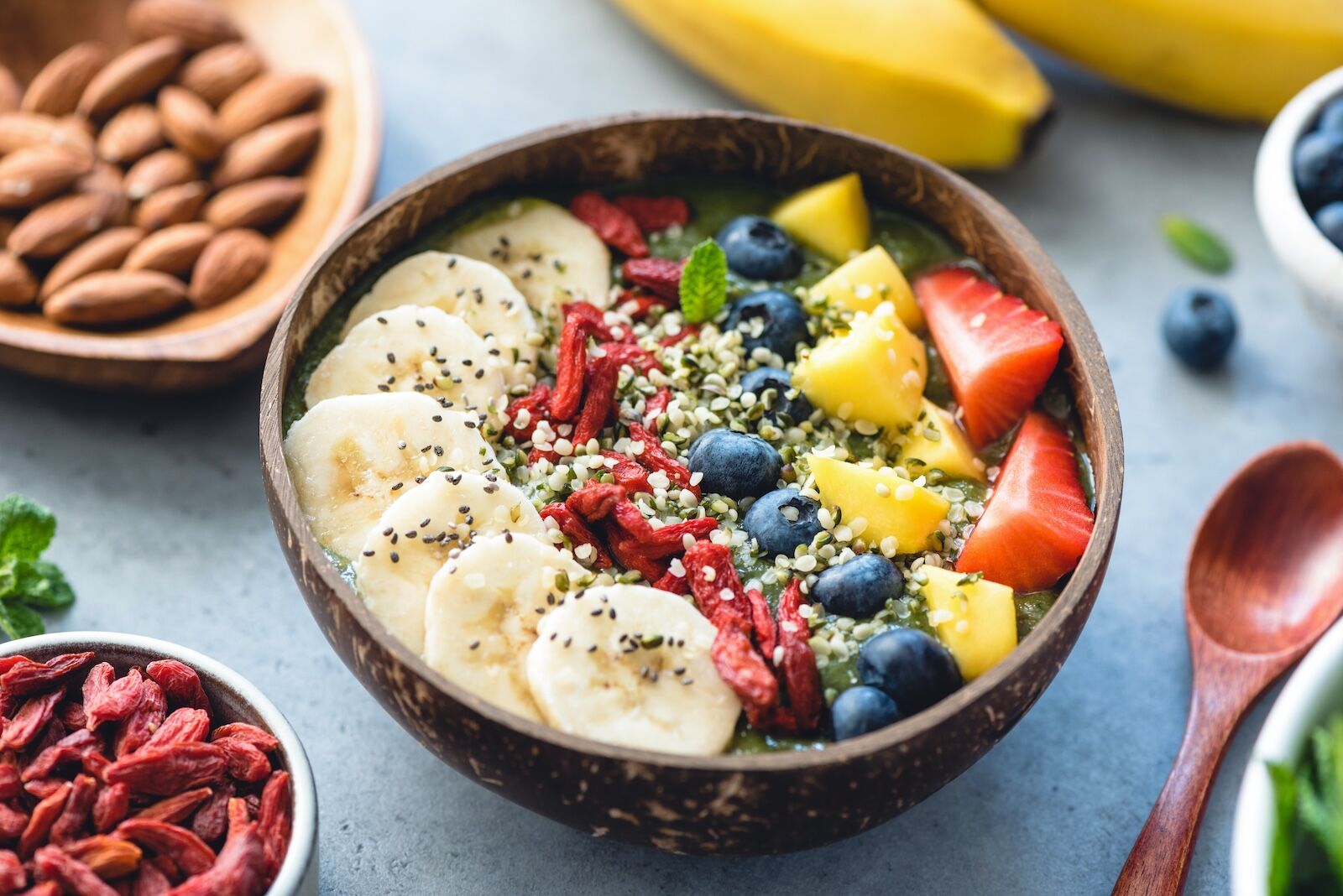 Superfood,Smoothie,In,Coconut,Bowl,With,Fruits,And,Seeds,Toppings.