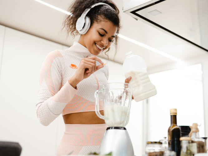 young woman making smoothie