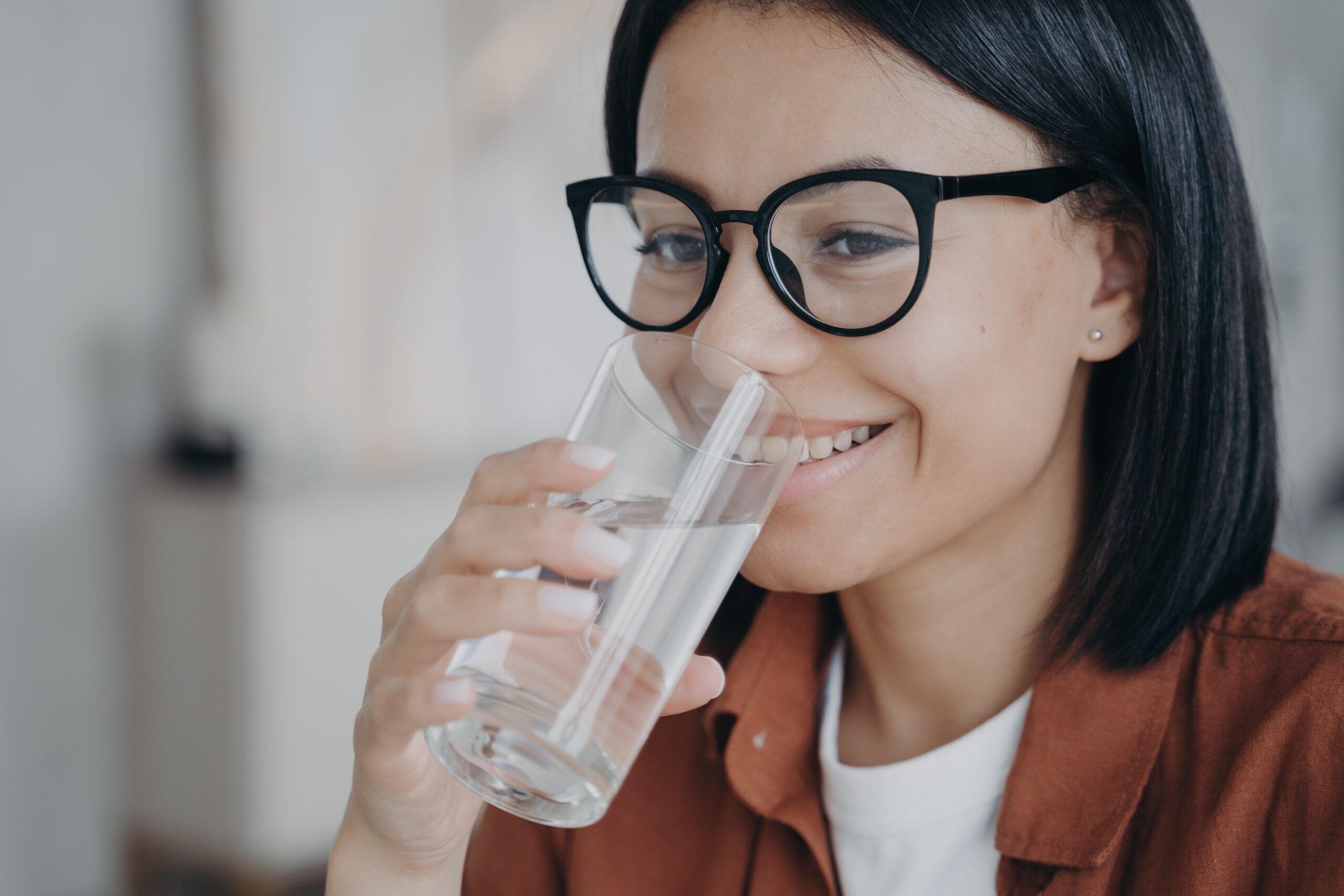 Happy,Thirsty,Young,Woman,Wearing,Glasses,Holding,Glass,,Drinking,Filtered