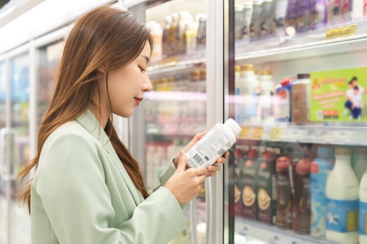Woman looking at food label