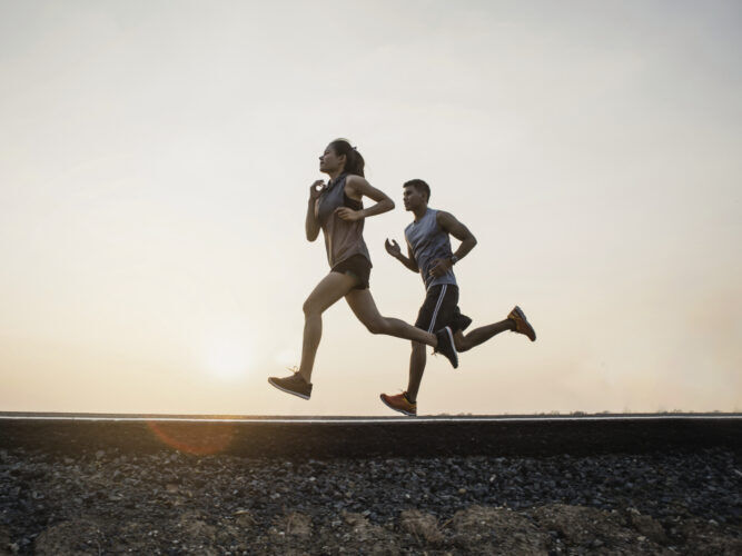 two runners on a jog during sunrise