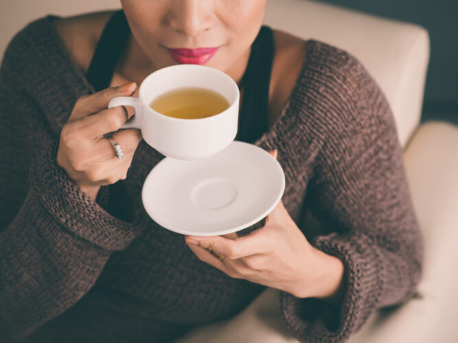 woman sipping on a tea