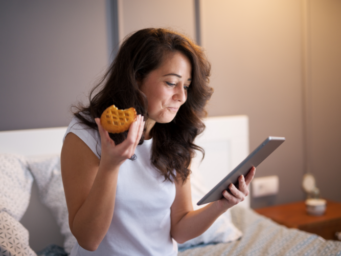 woman eating a hand pie before going to bed